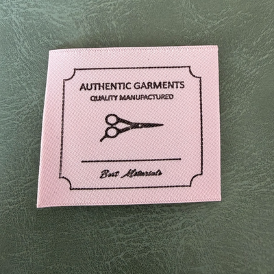Jacquard woven label LBL 0058 4 x 3.5 cm – pink base with black letters, soft premium design, with logo