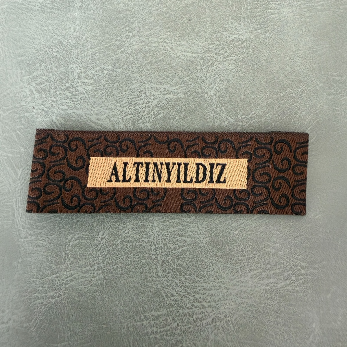 Jacquard woven label LBL 0042 6.5 x 2 cm – unique brand design with woven lettering, soft premium style, with logo