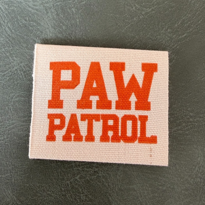 Printed canvas label LBL 0064 4 x 4 cm – with orange letters, soft premium design, with logo