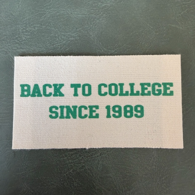 Printed canvas label LBL 0071 7.5 x 4 cm – with green print, soft premium design, with logo